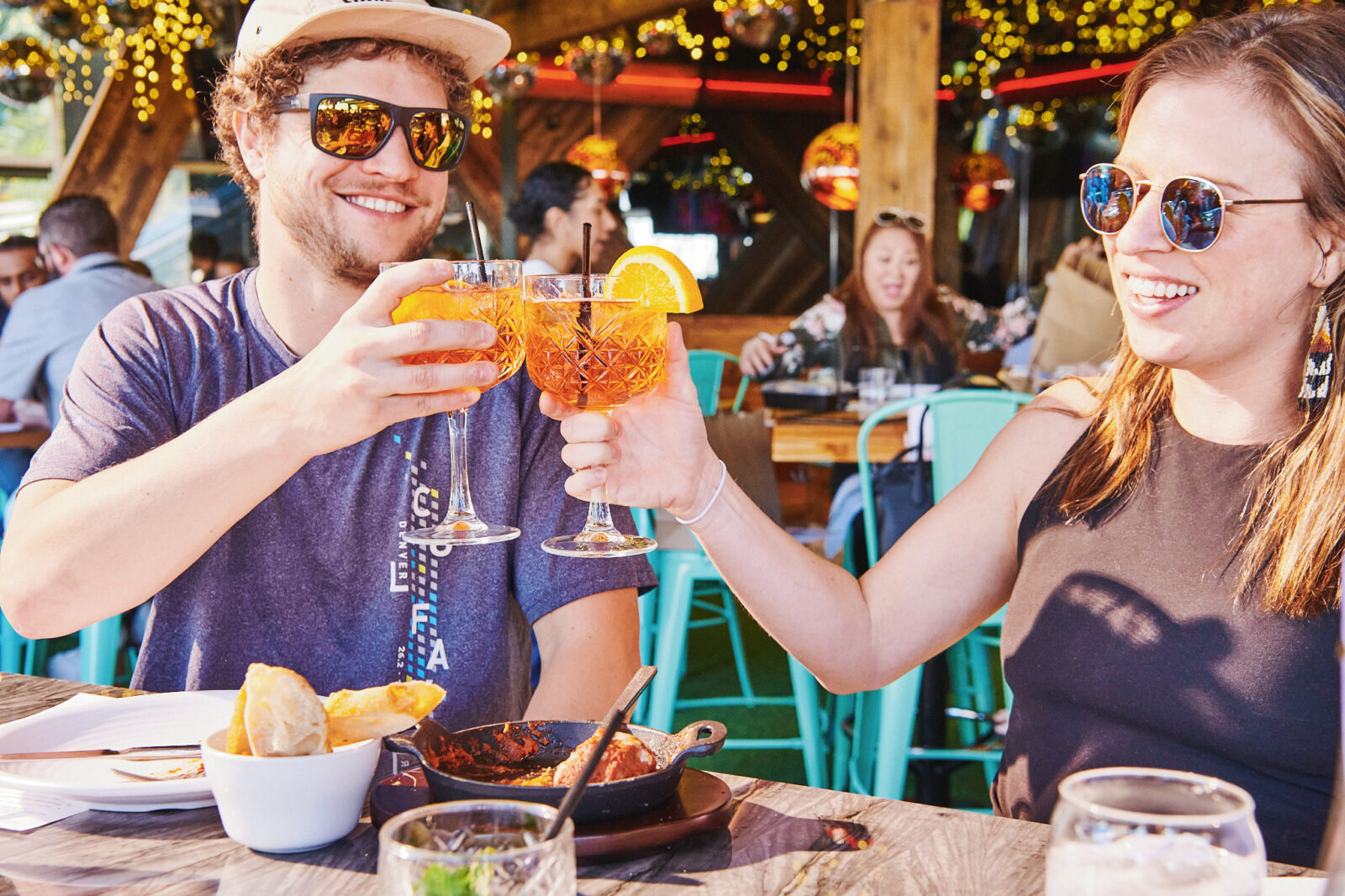 A couple cheersing their drinks at Happy Camper for Valentine's Day.