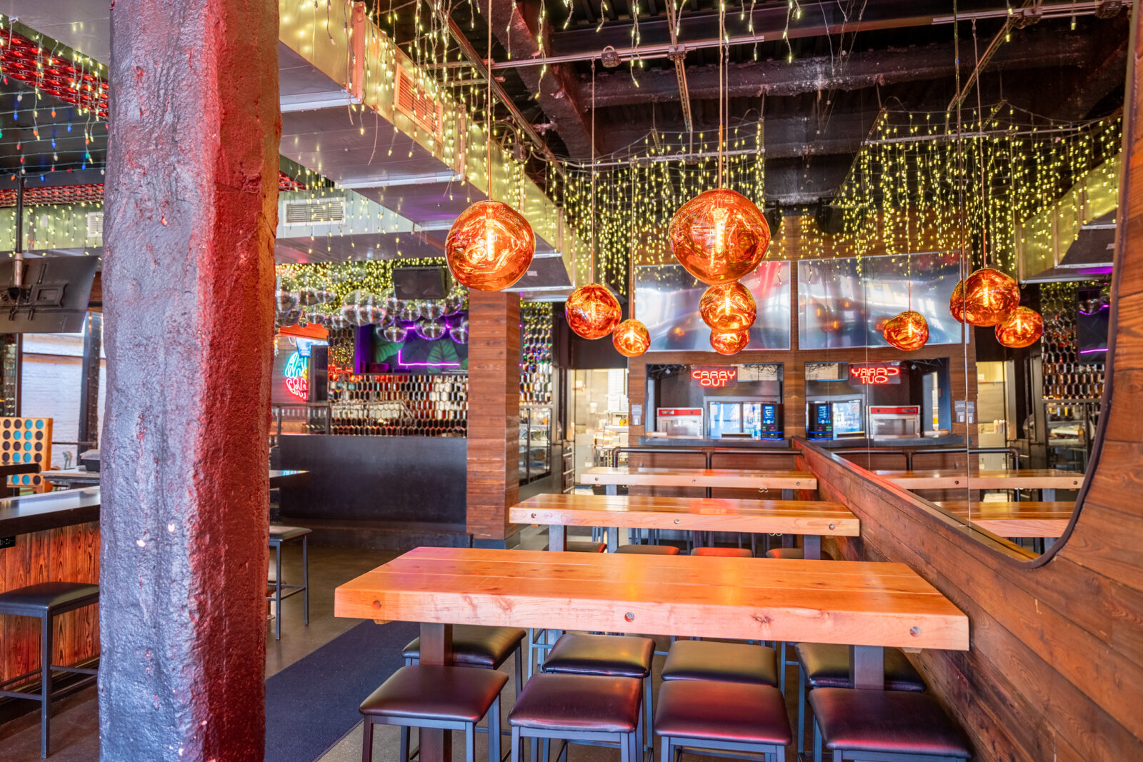slide 2 of 2 - Hightop communal tables, icicle lights, indoor space