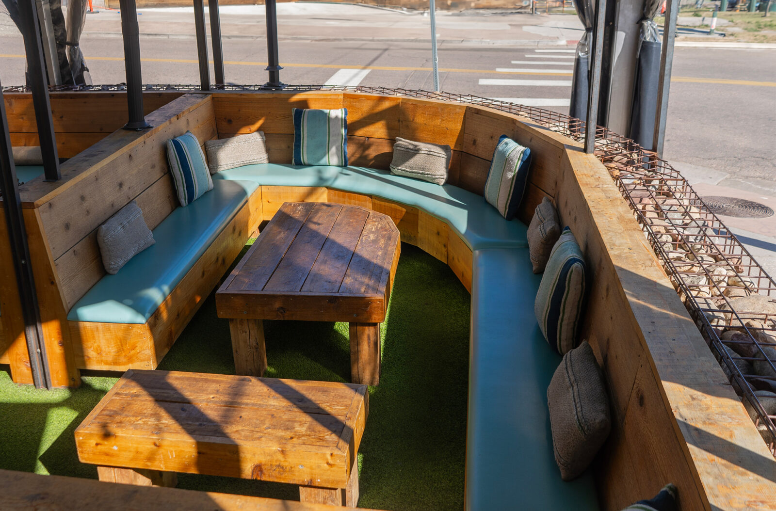 slide 1 of 3 - Cabana seating, with pillows on a patio space