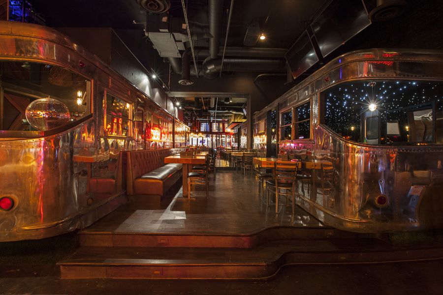 booth seating set between two life sized antique metal train cars