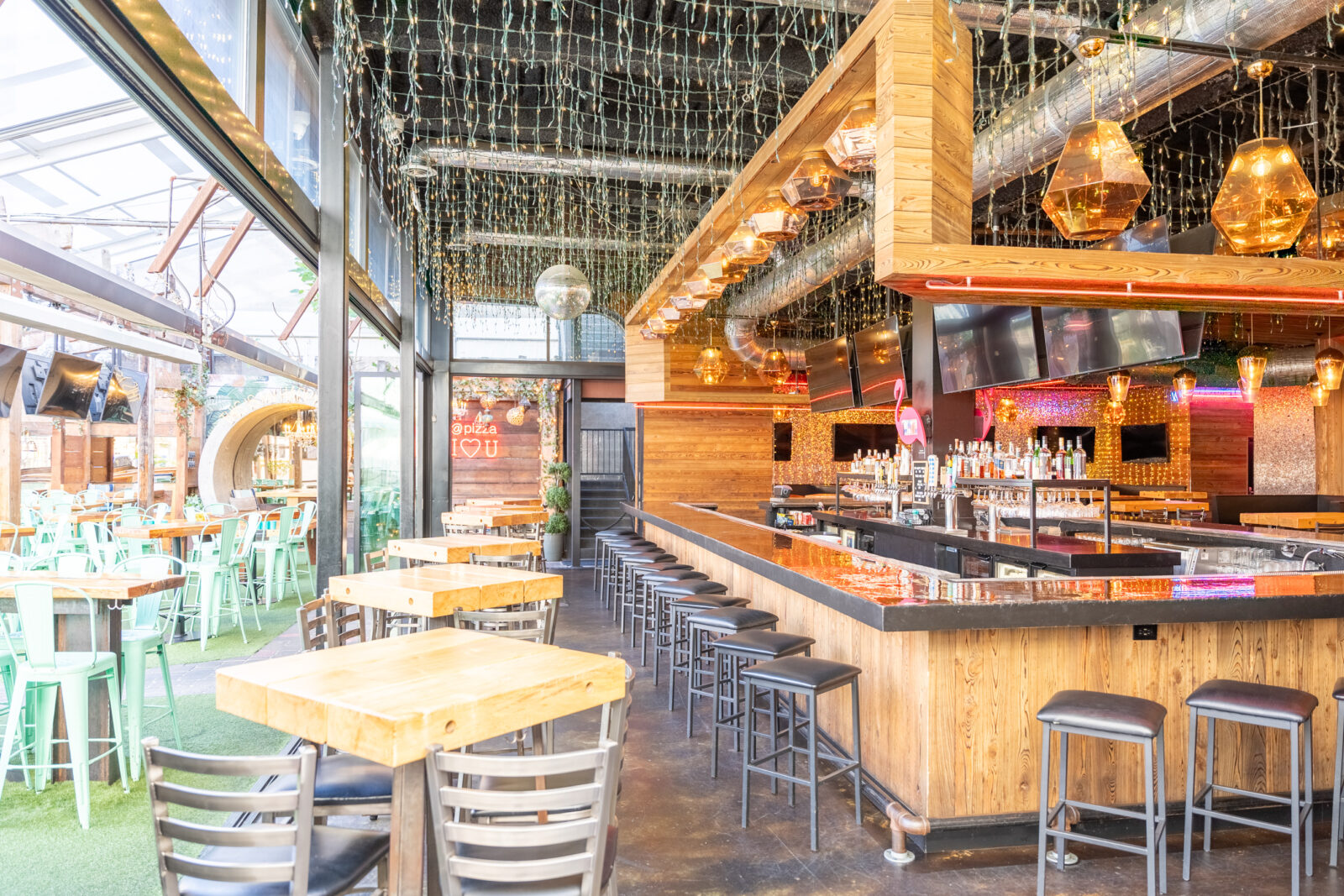 slide 3 of 3 - 360 bar, high top bar tables, tvs, open air windows