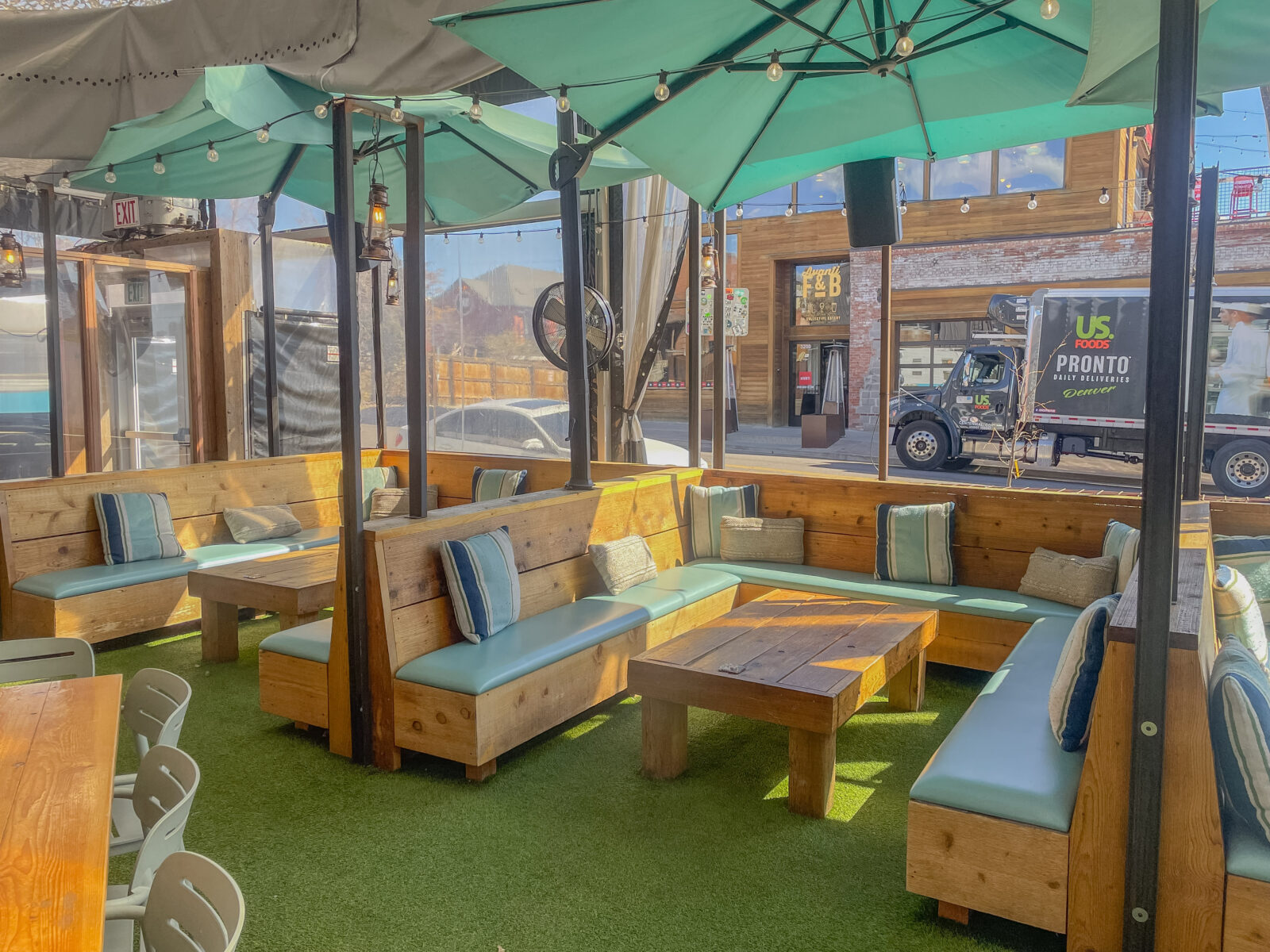 slide 2 of 3 - Cabana seating on an outdoor patio space