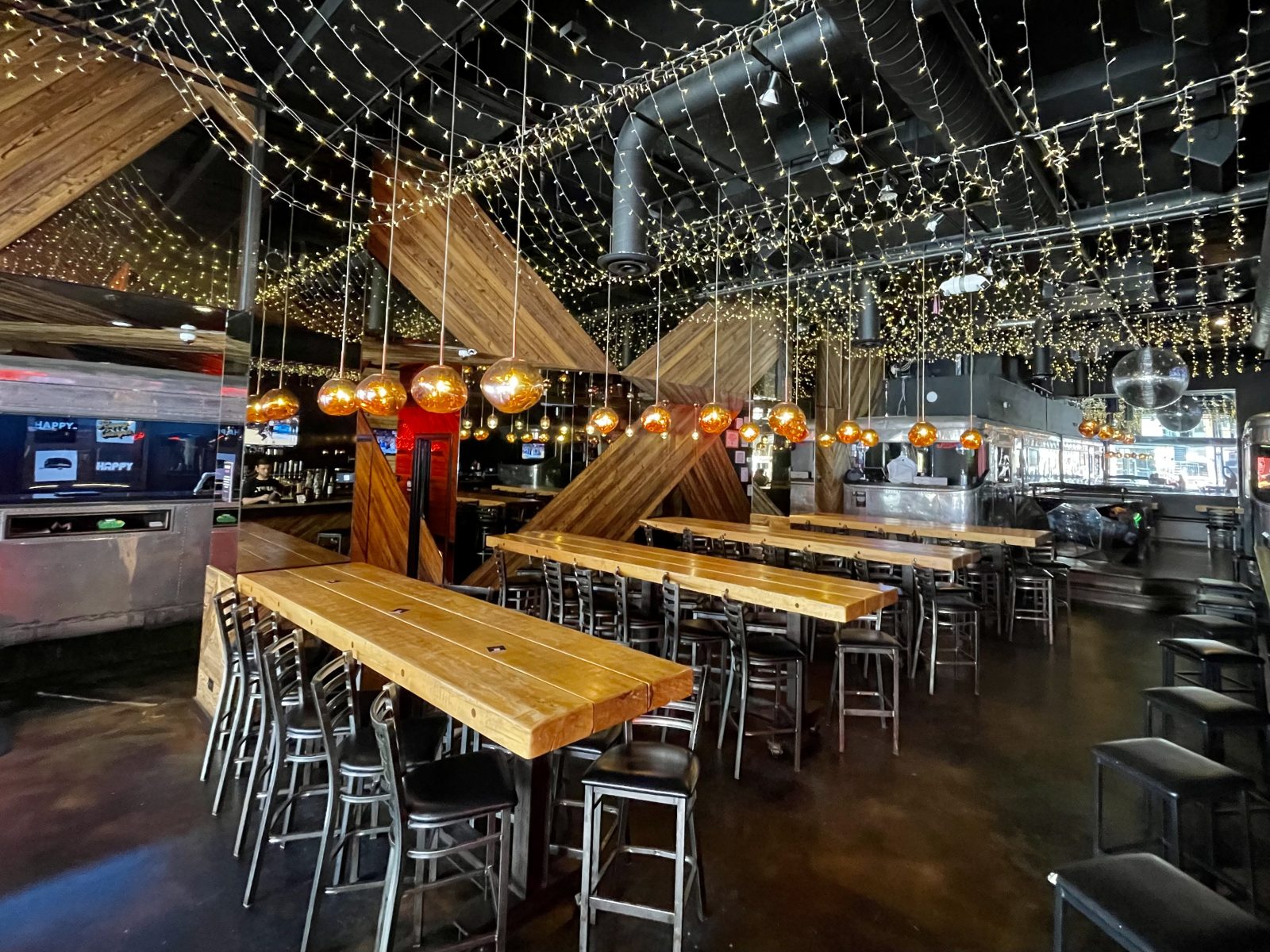 main bar filled with lights and communal tables