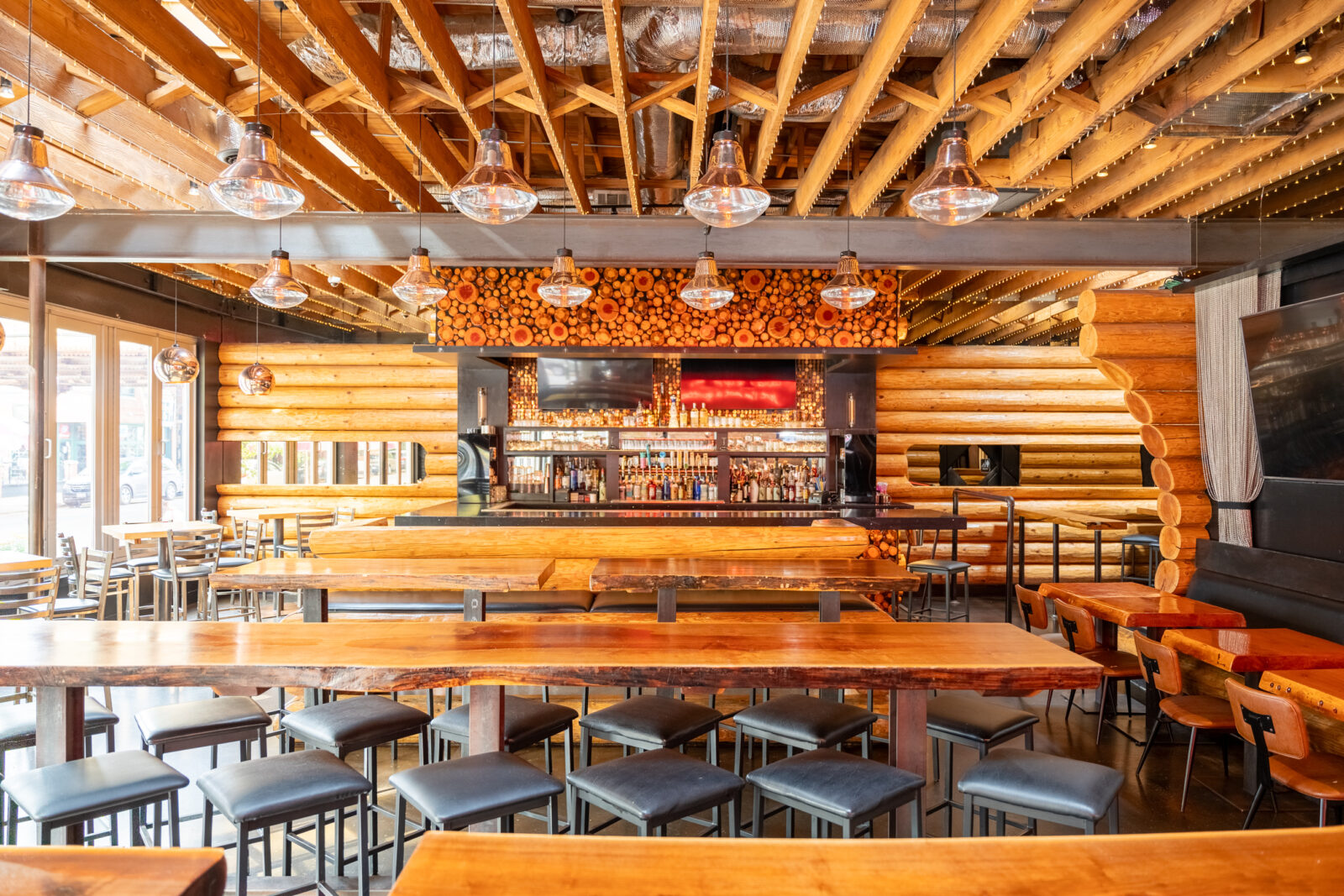 slide 3 of 5 - Inside log cabin style bar area and high top booth seating