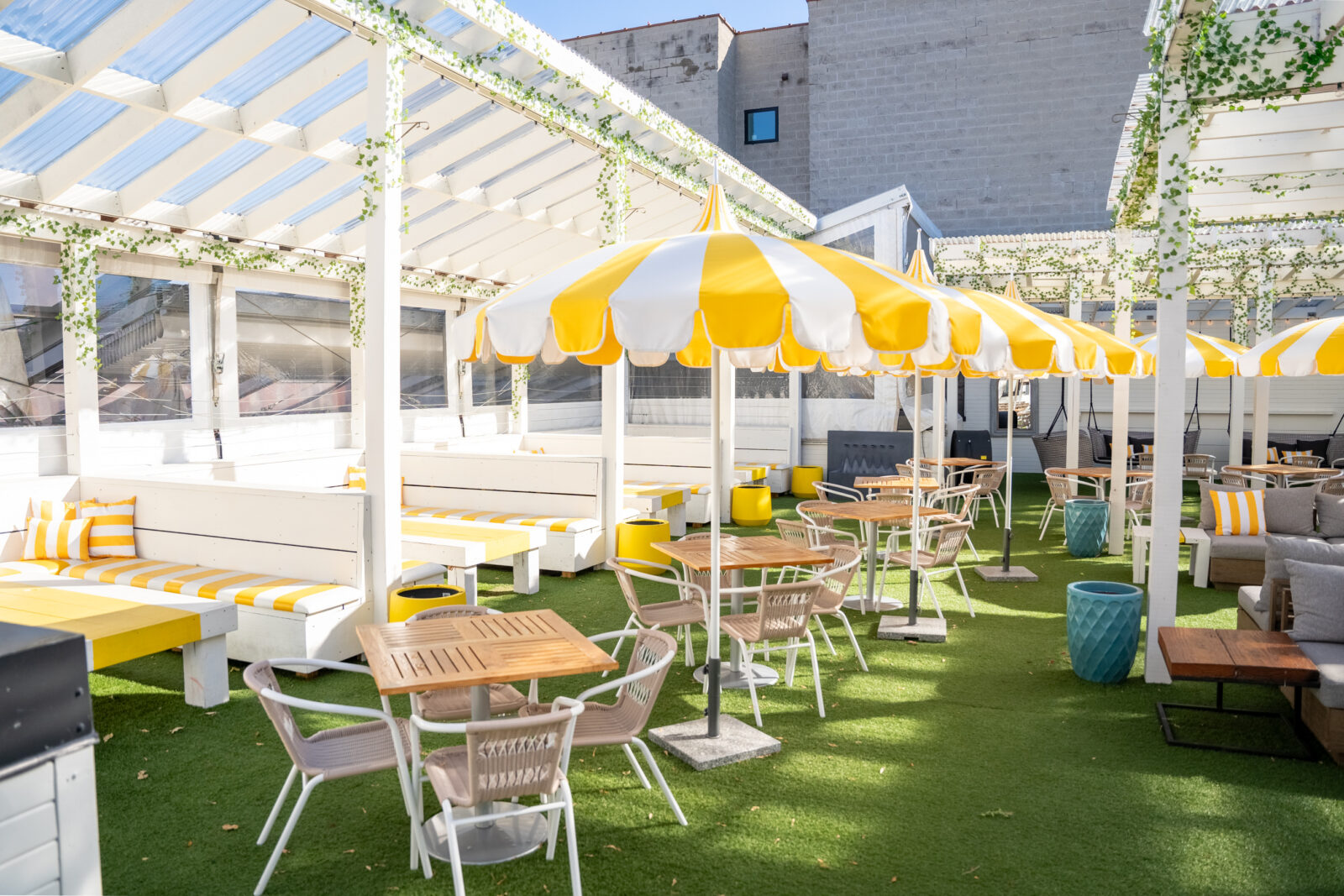 slide 1 of 1 - Rooftop space, cabanas seating, yellwo and white umbrellas