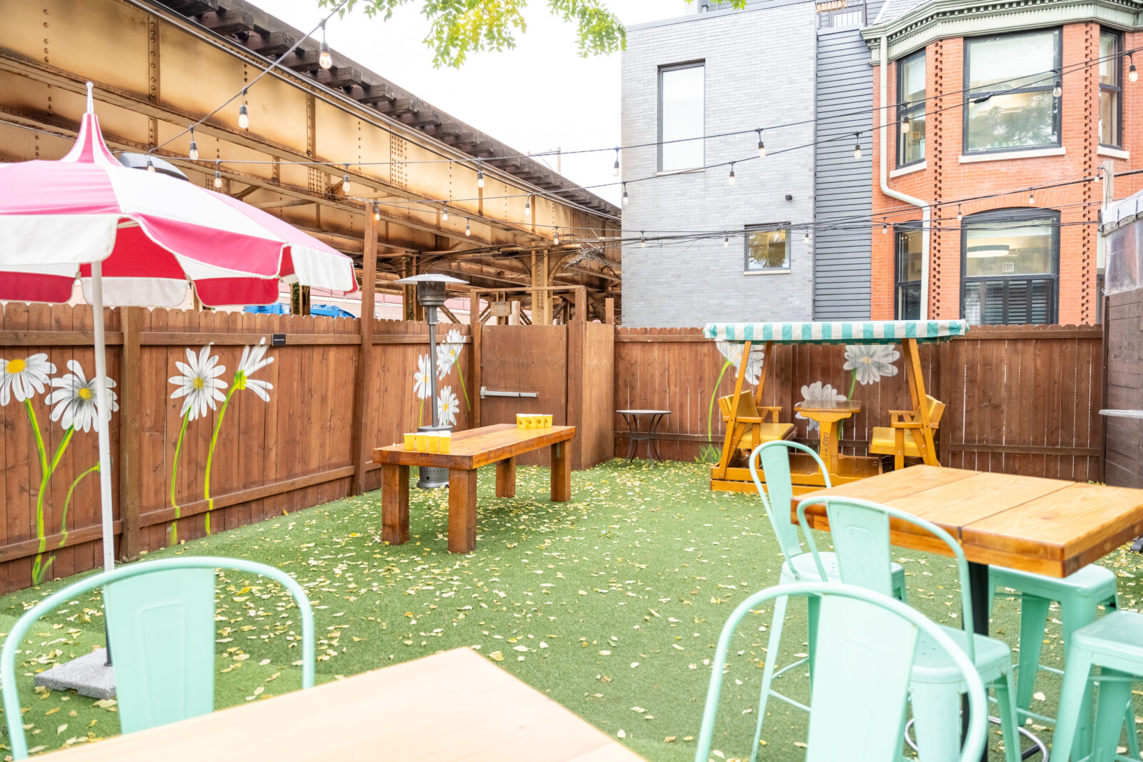 slide 2 of 4 - Outdoor patio, beer pong set up, bench seating and high top tables