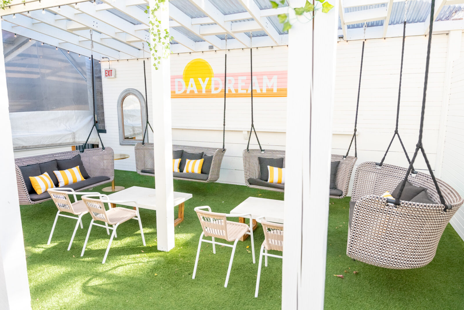 Swing style seating, low top seating, white walls with