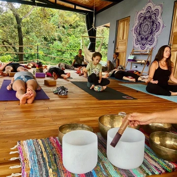 Yoga teacher training students in a lush outdoor setting, emphasizing the importance of environment.