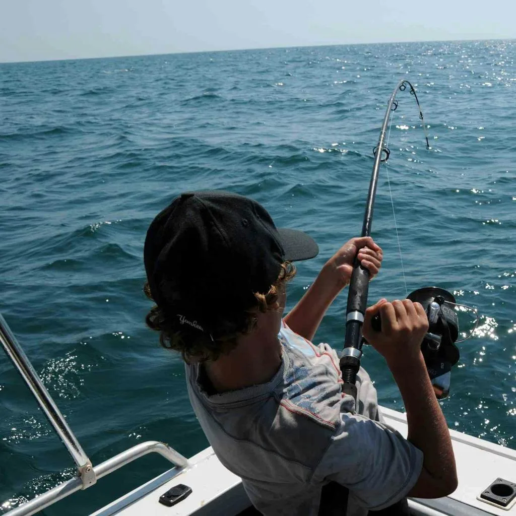 Reeling in a Fish deep sea fishing in Hawaii