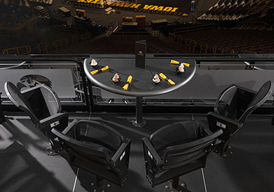 Four chairs around a half circle table on the terrace at Carver-Hawkeye Arena