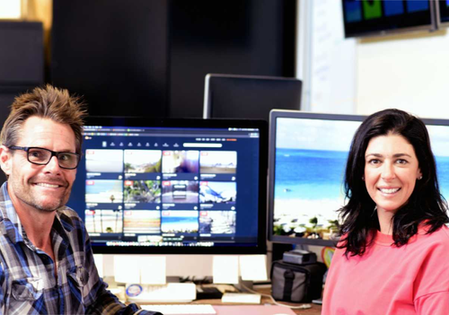 Tim and Tiffany Sears In Front of Computer Monitors