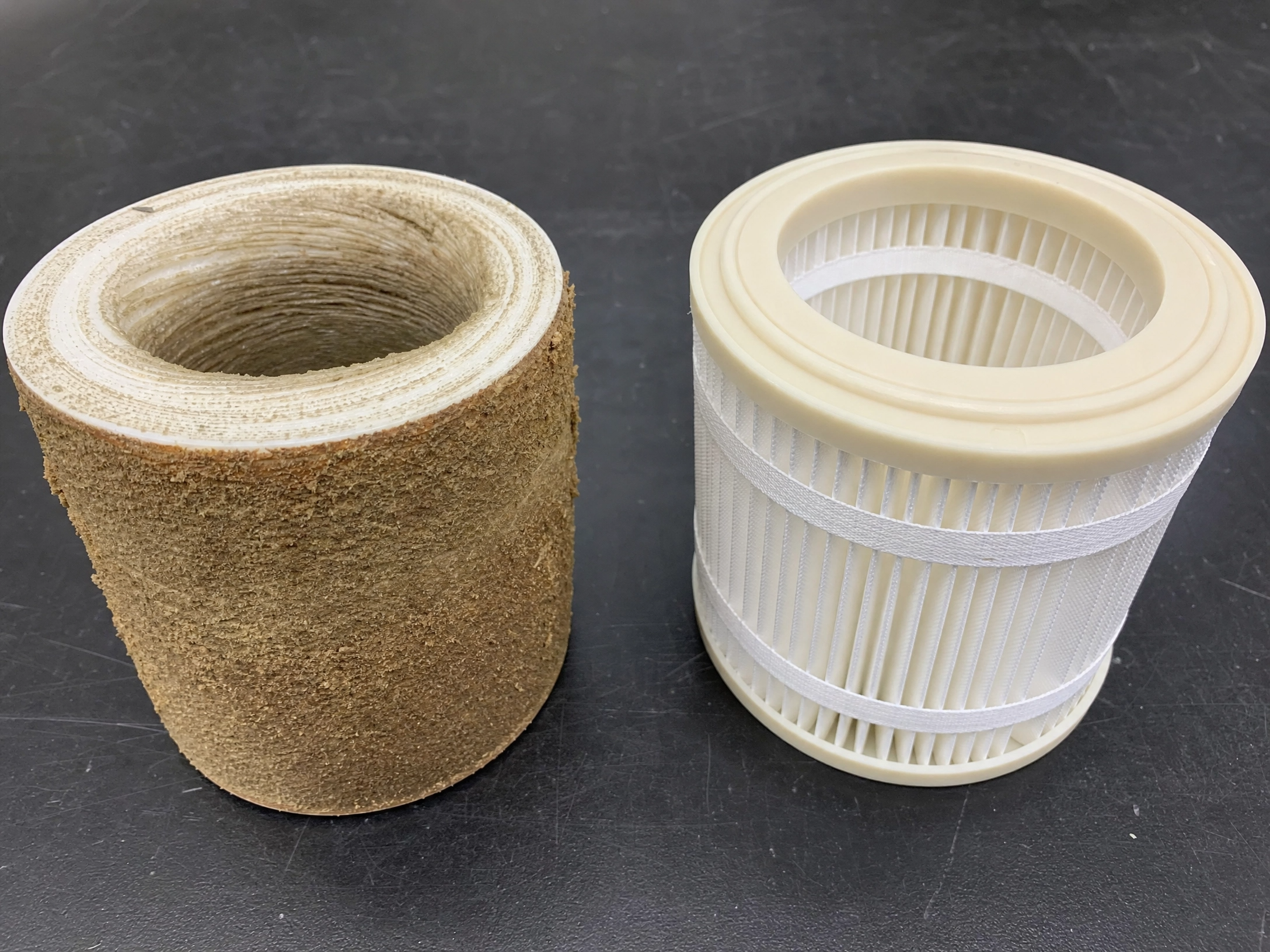 Blinded spun graded-density sediment cartridge compared to intact pleated polyester cartridge showing outer-layer loading failure versus distributed pleat geometry