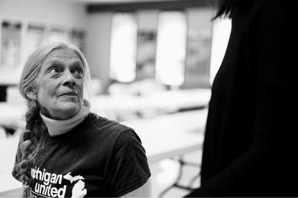 Black and white photo of a woman looking up wearing a "Michigan United" shirt