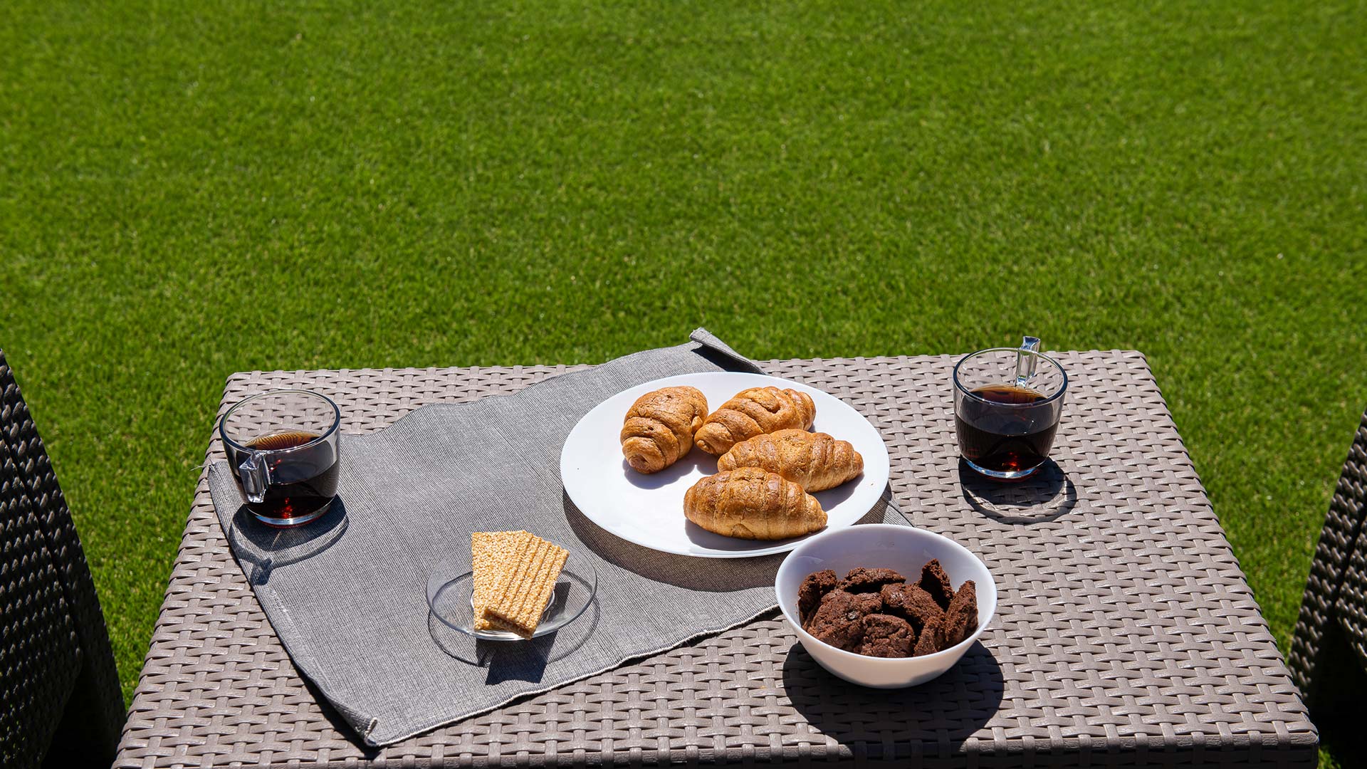 A table at the lawn with breakfast on it