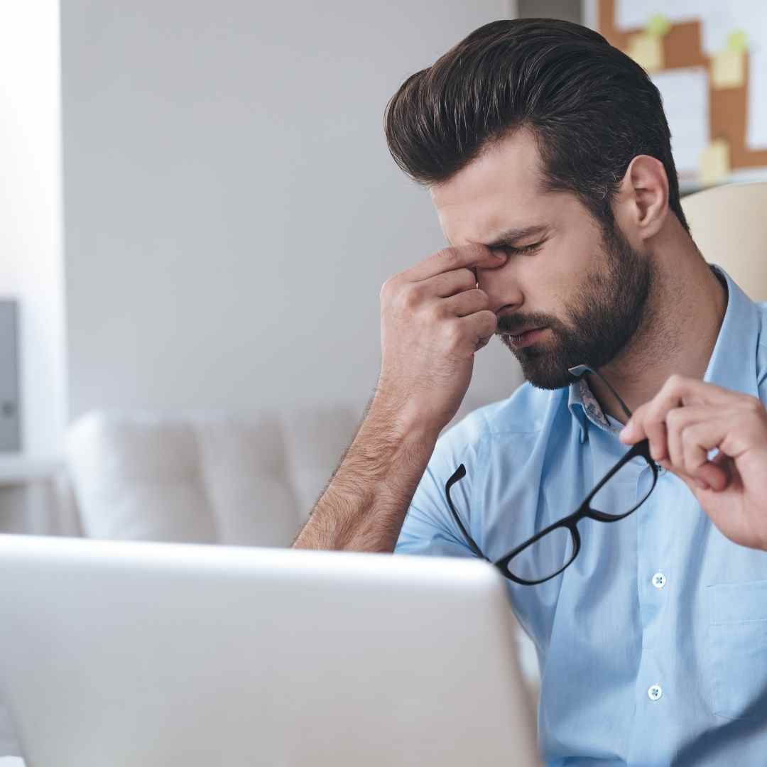 Stressed out man sitting in front of his laptop