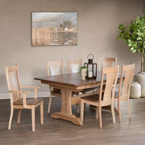 Solid wood trestle dining table with a dark walnut top and light oak base, surrounded by six matching wooden dining chairs.