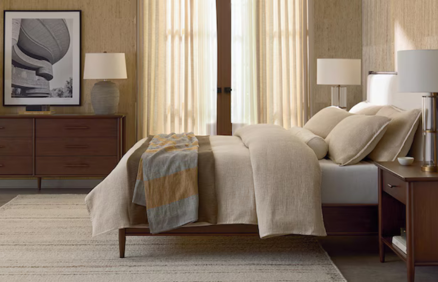 Bassett Copenhagen bedroom set featuring a dressed bed in a soft room with warm colored walls and linens.