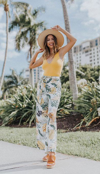 Embrace the tropical look via a V-neck knit top that you can style with summery wide-leg pants and a wedge. Finish it up with a floppy straw hat to punch up your look. 23 Summer Vacation Outfits To Make Your Next Trip Stylish