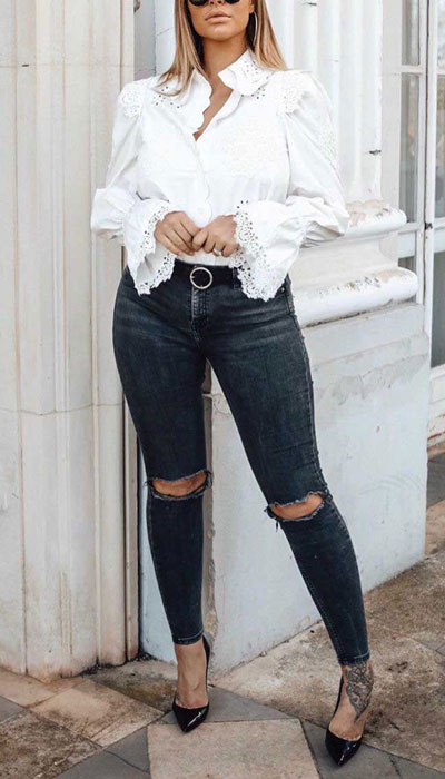 white embroidered sleeve top with black ripped skinny jeans and a pair of black pumps