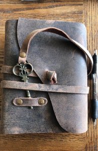 Ancient looking blank journal-heavy leather cover…