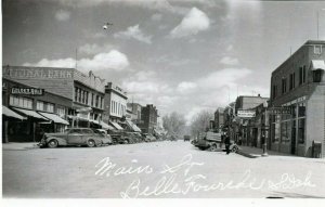 Vtg Main Street View Belle Fourche SD Old Cars Bank Signs RPPC 1930s Postcard