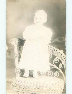 Pre-1917 rppc SMILING BABY ON ANTIQUE RATTAN CHAIR o2378