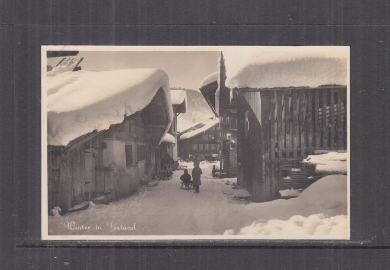 SWITZERLAND, GSTAAD, VILLAGE SCENE IN WINTER, c1930 ppc., unused.