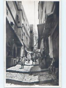 old rppc PEOPLE AND SHOPS IN THE STREET country of Algeria HM1389