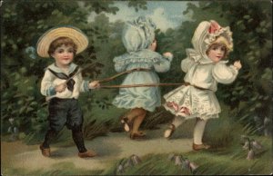 Children Playing Boy Ties Up Little Girls Willow Switch c1910 Vintage Postcard