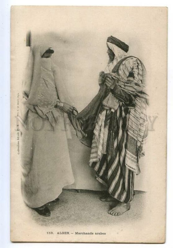 497167 Algeria girl in veil looks at goods from seller Vintage Deley postcard