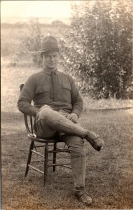 Real Photo Postcard Military Soldier Man Sitting in Chair Outside