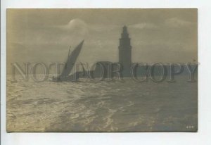 438927 sailboat and lighthouse at sunset Vintage photo postcard