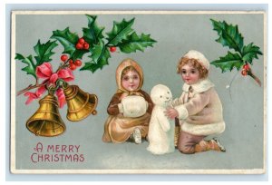 c1910 Children Building Snow Man Bells Holly Merry Christmas Embossed Postcard