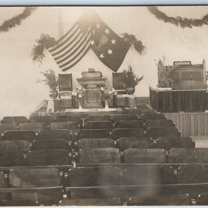 c1910s Unknown Event Room RPPC US Flag Seats Flowers Speaker Stage Ceremony A203