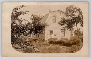 RPPC Two Woman posing in the Garden of thier Home Gambrel Roof Postcard C21
