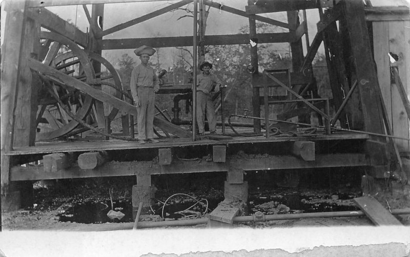 RPPC MEN MACHINERY CIGARETTES REAL PHOTO POSTCARD (c. 1910)