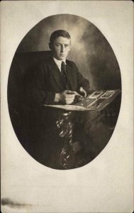 Young in Studio w/ His Postcard Album Real Photo Postcard - Deltiology c1910