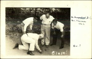 Men Playing Horseshoe Game - Cheboygan MI Cancel Real Photo Postcard