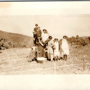 c1910s Fun Group People Outdoor Farm RPPC Stand Rock Windy Hat Young Women A283