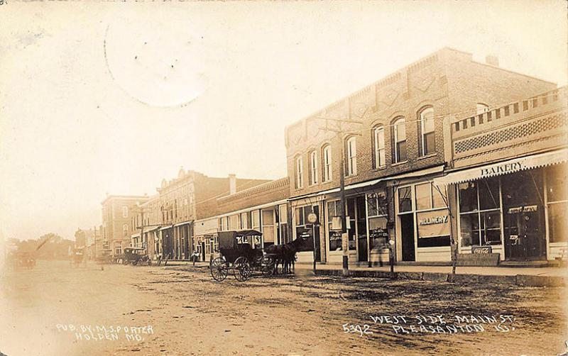 Pleasanton KS Dirt Street Horse & Wagon Store Fronts Signed RPPC Postcard 