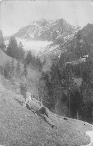 RPPC MAN RESTING ON MOUNTAIN WALKING CANE SWITZERLAND REAL PHOTO POSTCARD 1912