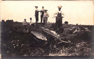WORKMEN WITH TOOLS POSING AT REMAINS OF DESTROYED BLDG REAL PHOTO POSTCARD 1909