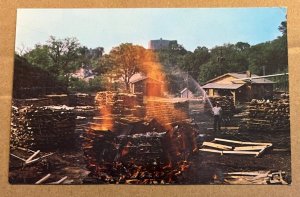 UNUSED PC - MAKING CHARCOAL AT JACK DANIEL'S DISTILLERY, LYNCHBURG, TENNESSEE