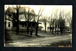 116 RPPC Burke, N.Y. South side of Main Street Looking West Child with books