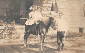 RPPC CHILDREN ON DONKEY BIKE WESTERVILLE OHIO REAL PHOTO POSTCARD 1908