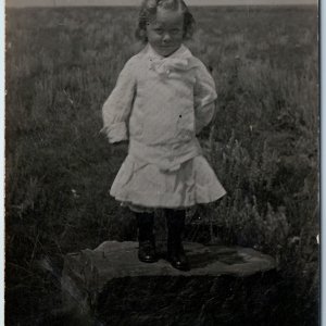 c1910s Cute Little Girl Outdoors RPPC Standing Rock Child Kid Prairie Field A212