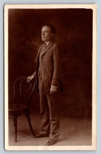 RPPC Man in Striped Tie Stands w/Hand on Chair AZO 1918-1930 VTG Postcard 1373