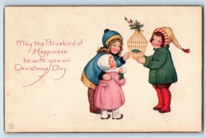 1921 Christmas Children With Doll Bluebird Cage Holly Berries Vintage Postcard