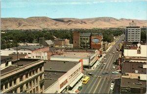 Looking East along Yakima Ave Masonic Temple, Eddy's Bread, Newberry's, old cars