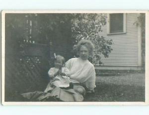 Pre-1917 rppc LITTLE GIRL HOLDING OBJECT SITS ON MOM'S LAP o2353